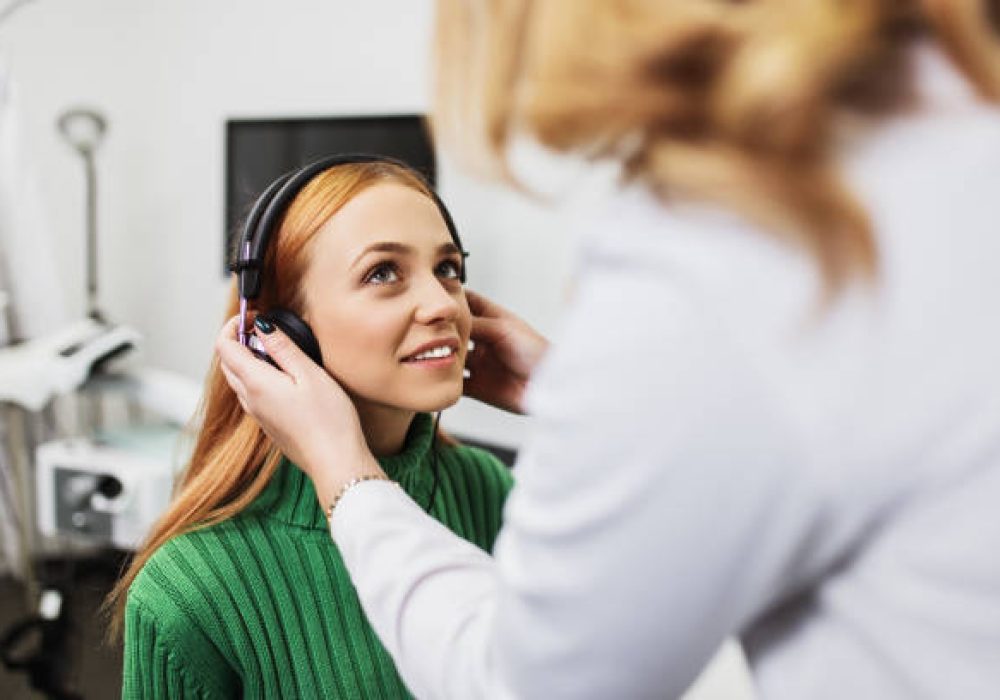 IMG_5158 Young adult redhead woman at medical examination or checkup in otolaryngologist's office